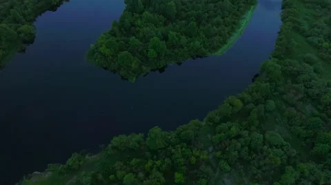 Aerial View. Flying over the river green trees at sunset with sun. Stock Footage 64963305