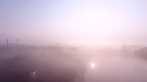 Aerial View. Flying over the river green trees at sunset with sun. Stock Footage 67813600