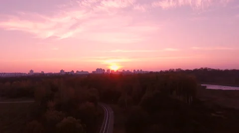 Aerial View. Flying over the river green trees at sunset with sun. Stock Footage 68853167