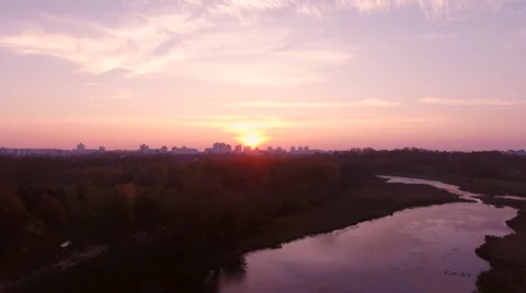 Aerial View. Flying over the river green trees at sunset with sun. Vídeos de archivo 68853577