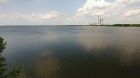 Aerial View. Flying over the river trees near the power plant. 動画素材 109461818