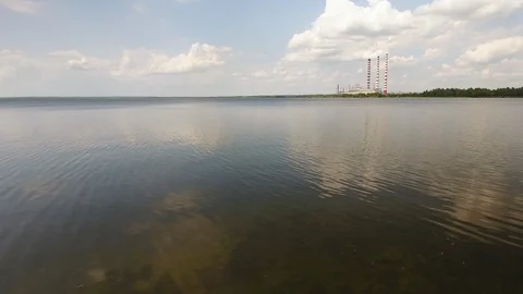 Aerial View. Flying over the river trees near the power plant. 動画素材 109462665