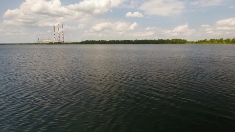 Aerial View. Flying over the river trees near the power plant. 動画素材 109462839