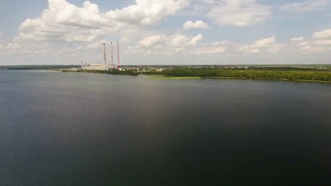 Aerial View. Flying over the river trees near the power plant. 動画素材 109463082