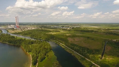 Aerial View. Flying over the river trees near the power plant. 動画素材 109463219