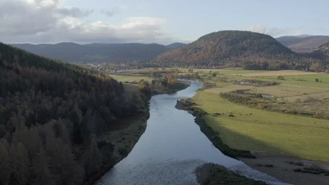 Aerial view flying over the River Dee towards the town of Ballater on a Video stock 120694920