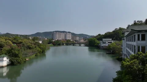 Aerial view flying over a river in a modern chinese city, guangzhou, china Video stock 324839262