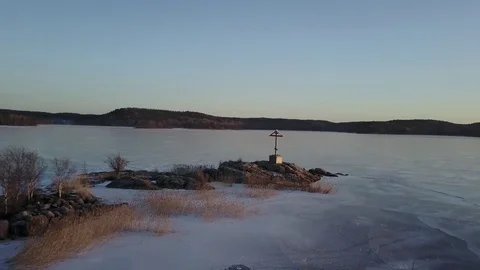 Aerial view: Flying over small island with an orthodox cross on it. Karelia Stock Footage 71252106