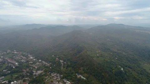 Aerial View: Flying over the small city covered by clouds. Aerial camera shot 動画素材 103265811