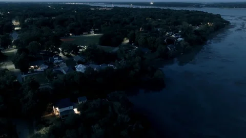 Aerial view flying over small coastal town at night Видео 239016715