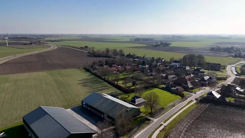 Aerial view flying over a small dutch village and surrounding farmland Видео 331189071