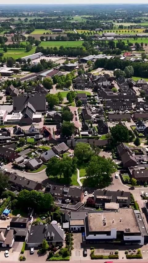 Aerial view flying over a small peaceful european town 動画素材 336496420