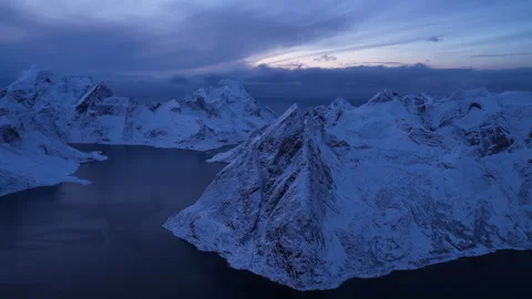 Aerial view flying over snowy lofoten mountains, Norway 動画素材 343360645