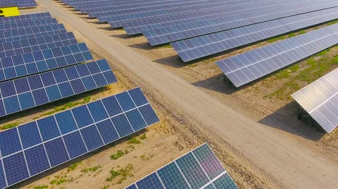 Aerial View. Flying over the solar power plant with sun. Solar panels and sun. Stock Footage 65175407