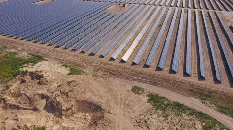 Aerial View. Flying over the solar power plant with sun. Solar panels and sun. Stock Footage 65238423