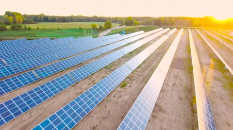 Aerial View. Flying over the solar power plant with sun. Solar panels and sun. Stock Footage 69033743