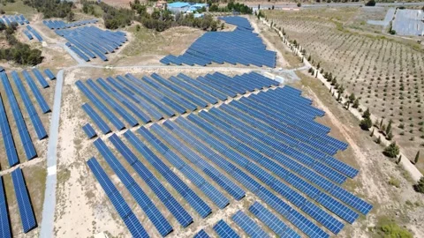 Aerial view flying over solar panel farm for clean energy Stock Footage 337705407