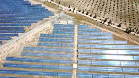 Aerial view flying over solar panel farm producing renewable energy Stock Footage 338196964