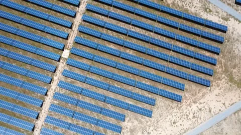Aerial view flying over solar panel farm for clean energy Видео 338196995