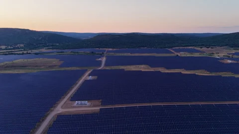 Aerial view flying over a solar panel farm generating clean renewable energy Stock Footage 344759656