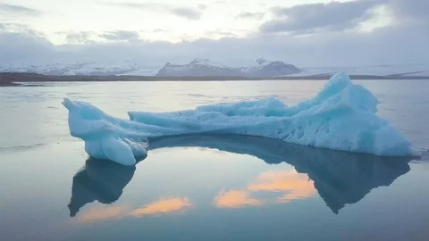 Aerial view flying over stunning icebergs floating in Jokulsarlon lagoon Iceland Stock Footage 128795166