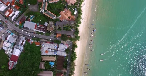 Aerial view flying over Thai island towards beautiful green mountains and white Stock Footage