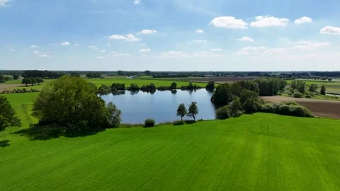 Aerial view flying over a tranquil lake in the green countryside 스톡 동영상 336594909