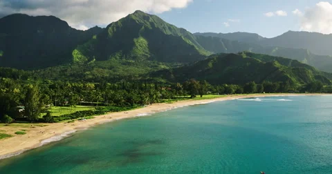 Aerial view flying over tropical blue ocean towards beautiful green mountains Stock Footage 63570638