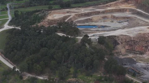 Aerial view flying over a vast open-cut mining quarry Видео 343643410