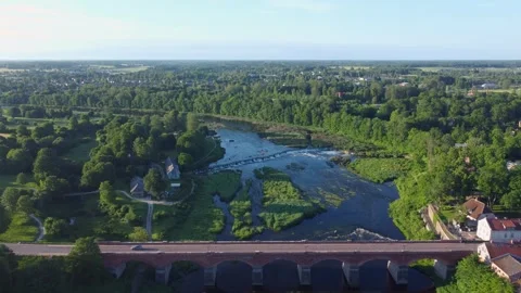 Aerial view flying over the Venta River and the Old Brick Bridge in Kuldiga.. Stock Footage 340636216