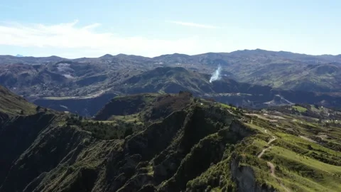 Aerial view flying over a walking track on the top of a large hill with a Stock Footage 142747106