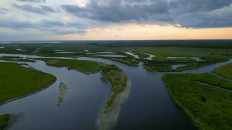 Aerial view flying over winding St Johns river delta at sunset in Florida Stock Footage 327439623