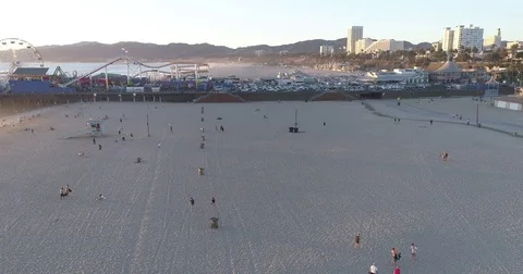 Aerial view flying parallel to the Santa Monica Beach Pier Stock Footage 81493437