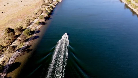 Aerial View Flying of River with Moving Boat and Farm Land Stock Footage 99018278