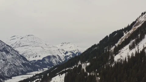 Aerial view flying sideways over a valley in austia alps. Stock Footage 125140877