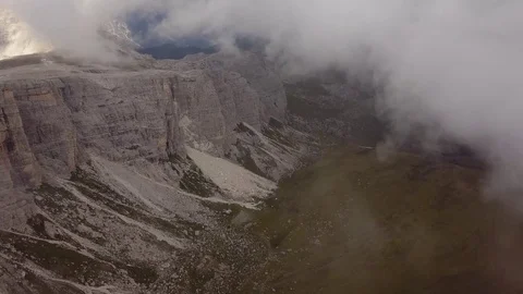 Aerial view flying through clouds and mist over the Dolomites Video stock 80146786