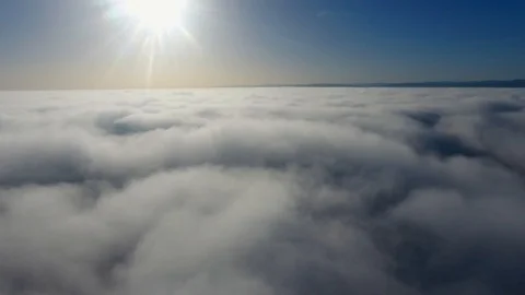 Aerial view, flying through clouds at sunset Stock Footage 98074063