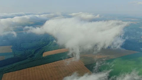 Aerial view, flying through the clouds above countryside scenery morning foggy Vidéo 112863940