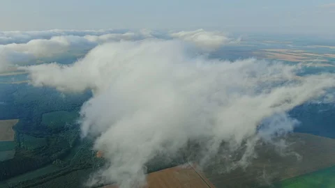 Aerial view, flying through the clouds above countryside scenery morning foggy Stock Footage 112864245