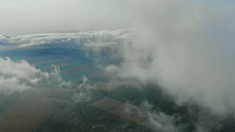 Aerial view, flying through the clouds above countryside scenery morning foggy Vídeo Stock 112864837