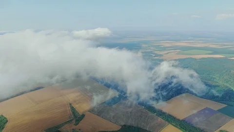Aerial view, flying through the clouds above countryside scenery morning foggy 動画素材 112868681