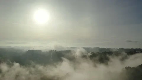 Aerial view, Flying through the clouds above mountain top. Overtake shot Stock Footage 199343624