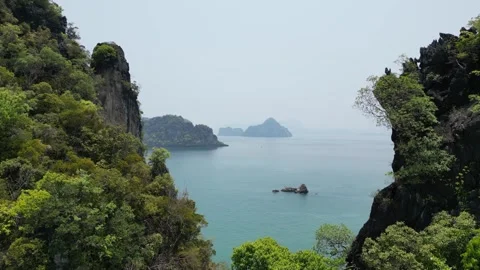 Aerial View Flying Through Limestone Cliffs in Krabi, Thailand Revealing a Stock Footage 335581294