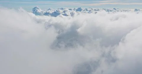 Aerial view flying through soft white clouds Stock Photos