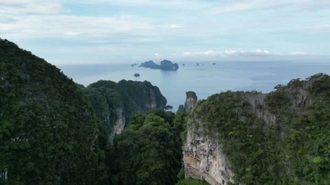 Aerial View Flying Through Tropical Jungle Cliffs in Krabi, Thailand Revealing Stock Footage 334724261