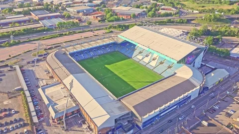 Aerial view flying toward Elland Road Stadium in Leeds, UK, with visible road Vídeo Stock 313656953