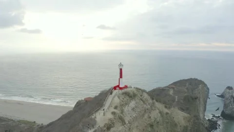 Aerial view, flying towards a light house standing high above the Pacific Ocean Stock Footage 146755465
