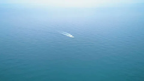 Aerial view of flying towards small luxury yacht in blue sea ocean water Stock Footage 111572096