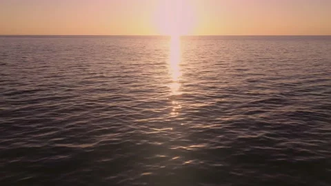 Aerial view flying towards sun tilting up with sun flare Video stock 168771526