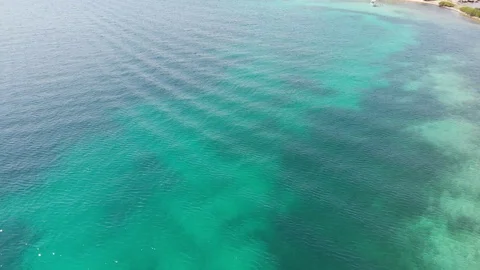 Aerial view. Flying very low over water, after soars up. Stock Footage 119376383